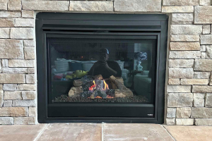 Black fireplace insert with centered flame and logs