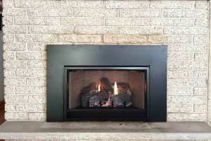 Traditional fireplace with stone surround and active fire