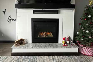 Modern white fireplace with clean design and fire