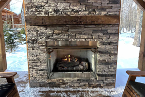Stone fireplace with thick mantel and firebox insert