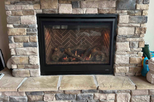 Built-in fireplace with patterned interior and burning fire