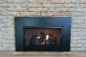 Fireplace insert with blue-toned glass and flames